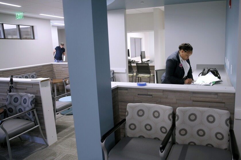 FILE - Anita Murphy, a Planned Parenthood executive, does paperwork in the waiting room during a media tour of the new Fairview Heights, Ill., facility on Oct. 2, 2019, prior to open that month. With abortion access increasingly restricted across much of the South and Midwest, two Illinois clinics near St. Louis on Friday, Jan. 21, 2022, announced a new logistics center to help abortion seekers get to their clinics. (Christian Gooden/St. Louis Post-Dispatch via AP, File)