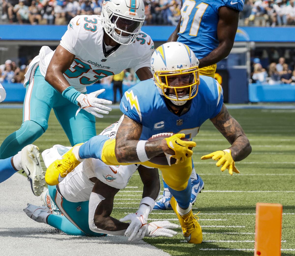 Chargers wide receiver Keenan Allen strains to gain yards against the Miami Dolphins at SoFi Stadium in September.