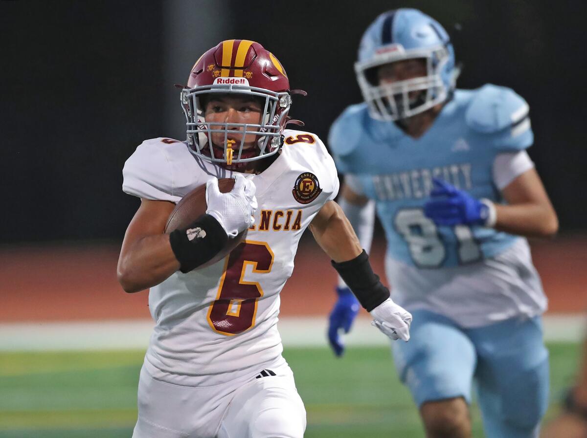 Estancia kick returner Brandon Bettinghausen (6)  runs around the defense for a touchdown against University.