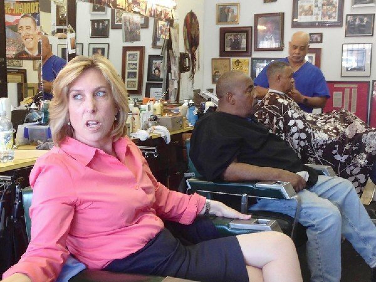 Mayoral candidate Wendy Greuel settles in for another chat with the regulars at Tolliver's barbershop in South Los Angeles.