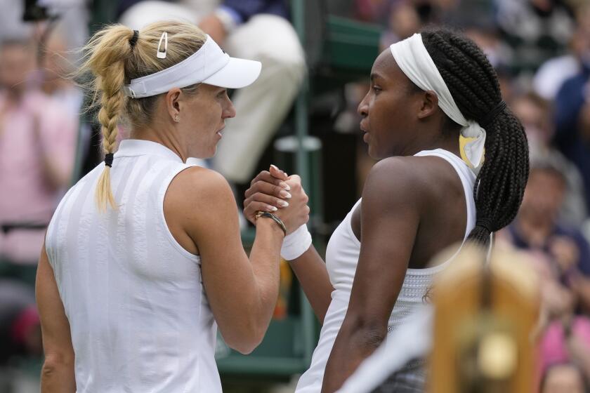 Germany's Angelique Kerber, left, greets Coco Gauff of the U.S. after winning the women's singles fourth round match