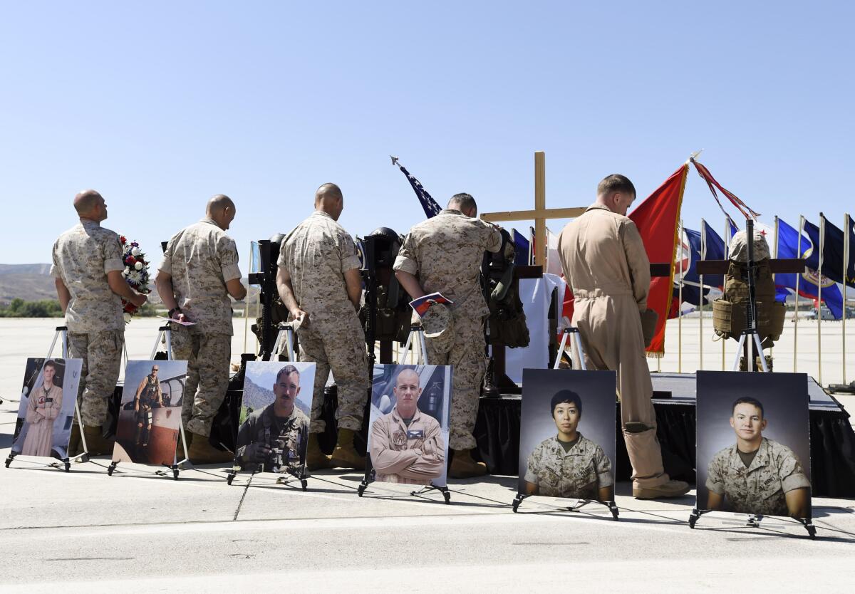Marines pay their respects after a memorial service at Camp Pendleton for six Marines killed in a helicopter crash in Nepal during a mission to aid stranded villagers after two earthquakes.