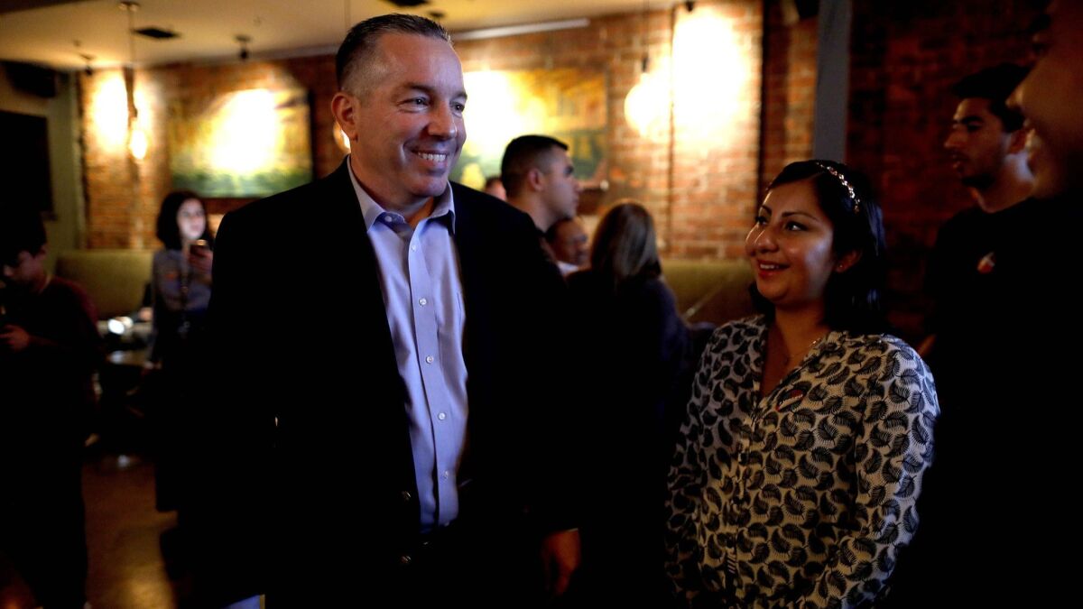 Alex Villanueva, challenger for Los Angeles County sheriff, with Elizabeth Yuson of Los Angeles on election night at Cities Restaurant in Los Angeles.