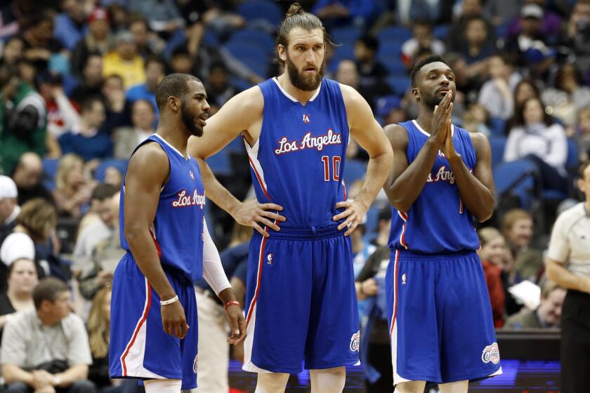 Chris Paul, Spencer Hawes and Jordan Hamilton talk during a break in the second half of a game March 2 against the Minnesota Timberwolves.