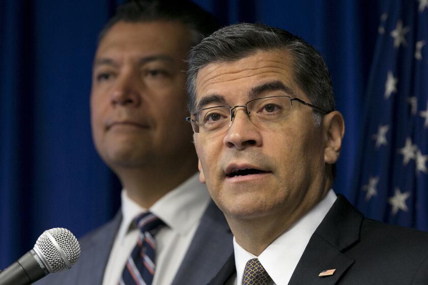 California Attorney General Xavier Becerra, right, flanked by Secretary of State Alex Padilla, discusses the lawsuit he intends to file against the Trump administration over the cancelation of the Deferred Action for Childhood Arrivals program, during a news conference, Tuesday, Sept. 5, 2017, in Sacramento, Calif. (AP Photo/Rich Pedroncelli)