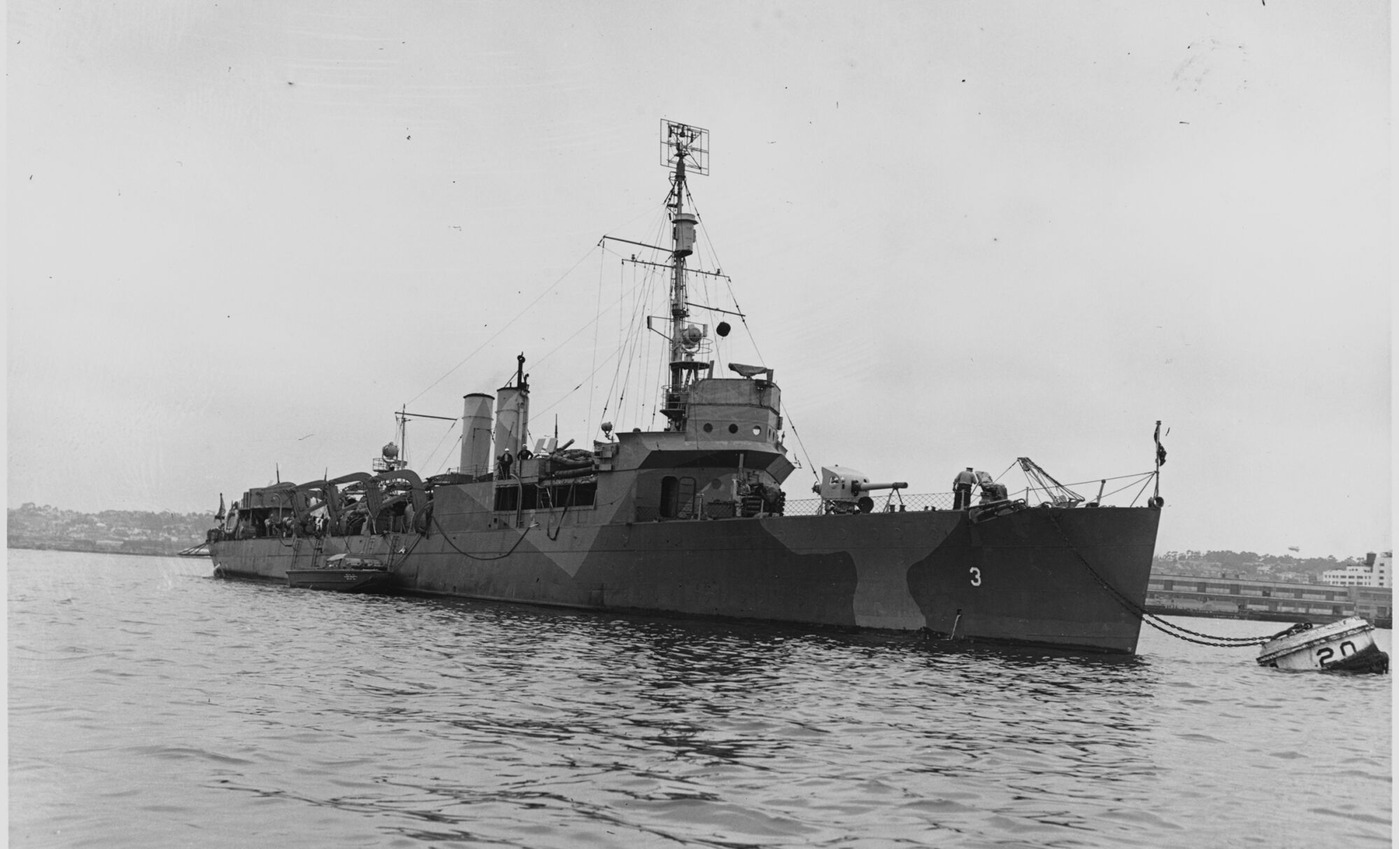 The destroyer-turned-transport U.S. Navy ship Gregory in port while painted in pattern camouflage.