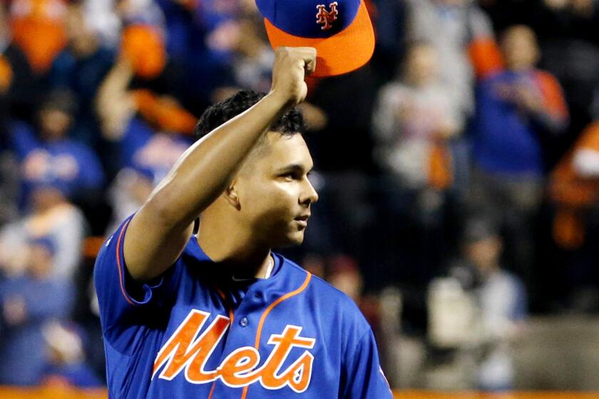 Mets shortstop Ruben Tejada acknowledges the fans at Citi Field before Game 3 of a National League division series between New York and the Dodgers.