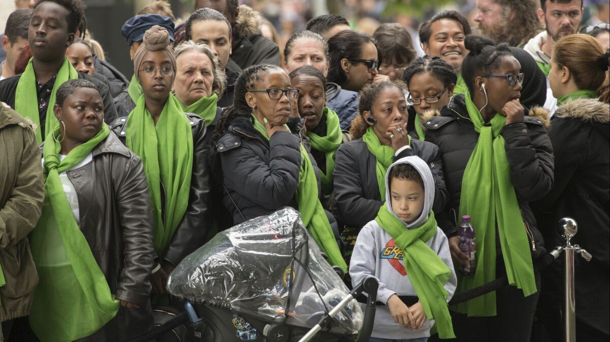 Families of victims of the Grenfell Tower disaster attend a service of remembrance in west London on Thursday.