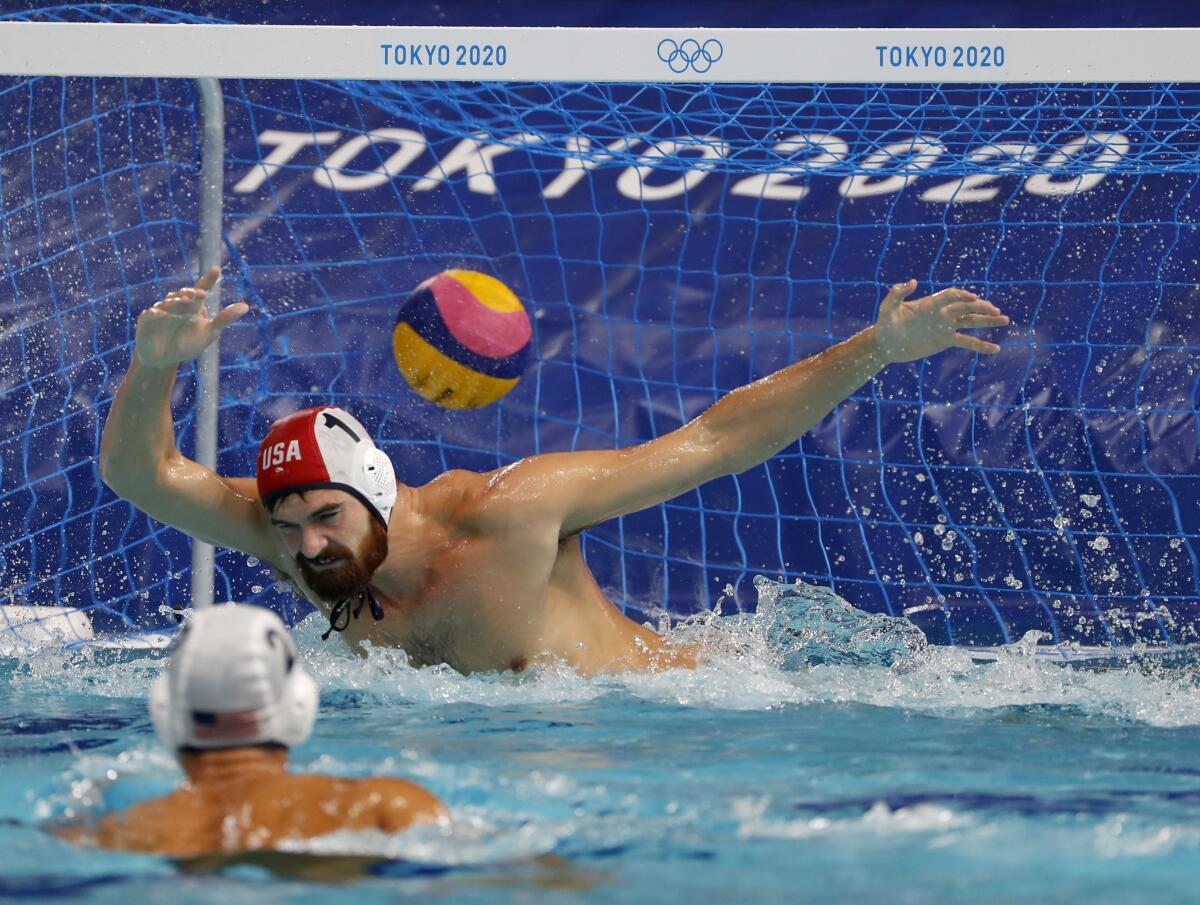 U.S. goalie Alex Wolf tries to stop a shot by Spain's Alberto Munarriz Egana.