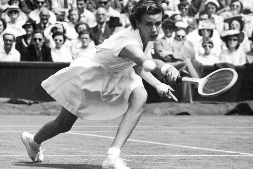 Doris Hart competes in a singles tennis match at Wimbledon in London in June 1951, when she won three Wimbledon titles in a single day. Hart, who won each Grand Slam tournament at least once, died Friday, May 29, 2015, at her Miami area home.