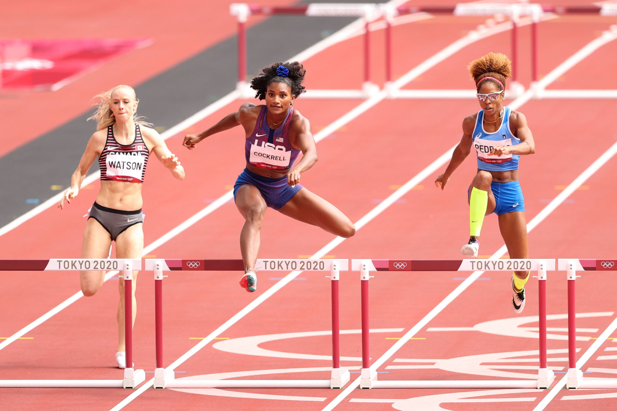 American Anna Cockrell, center, runs against Canada's Sage Watson and Italy's Yadisleidis in a 400-meter hurdles.
