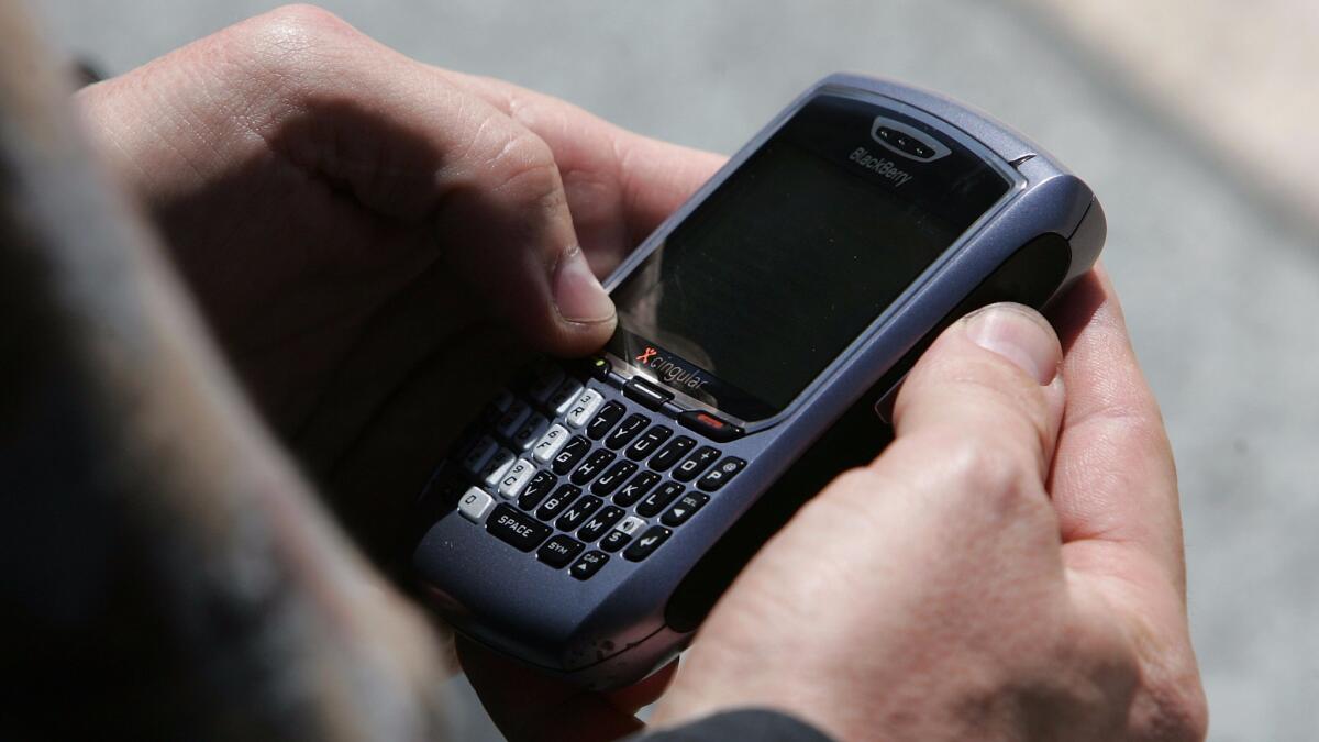 A man in San Francisco checks email on his Blackberry in 2007.