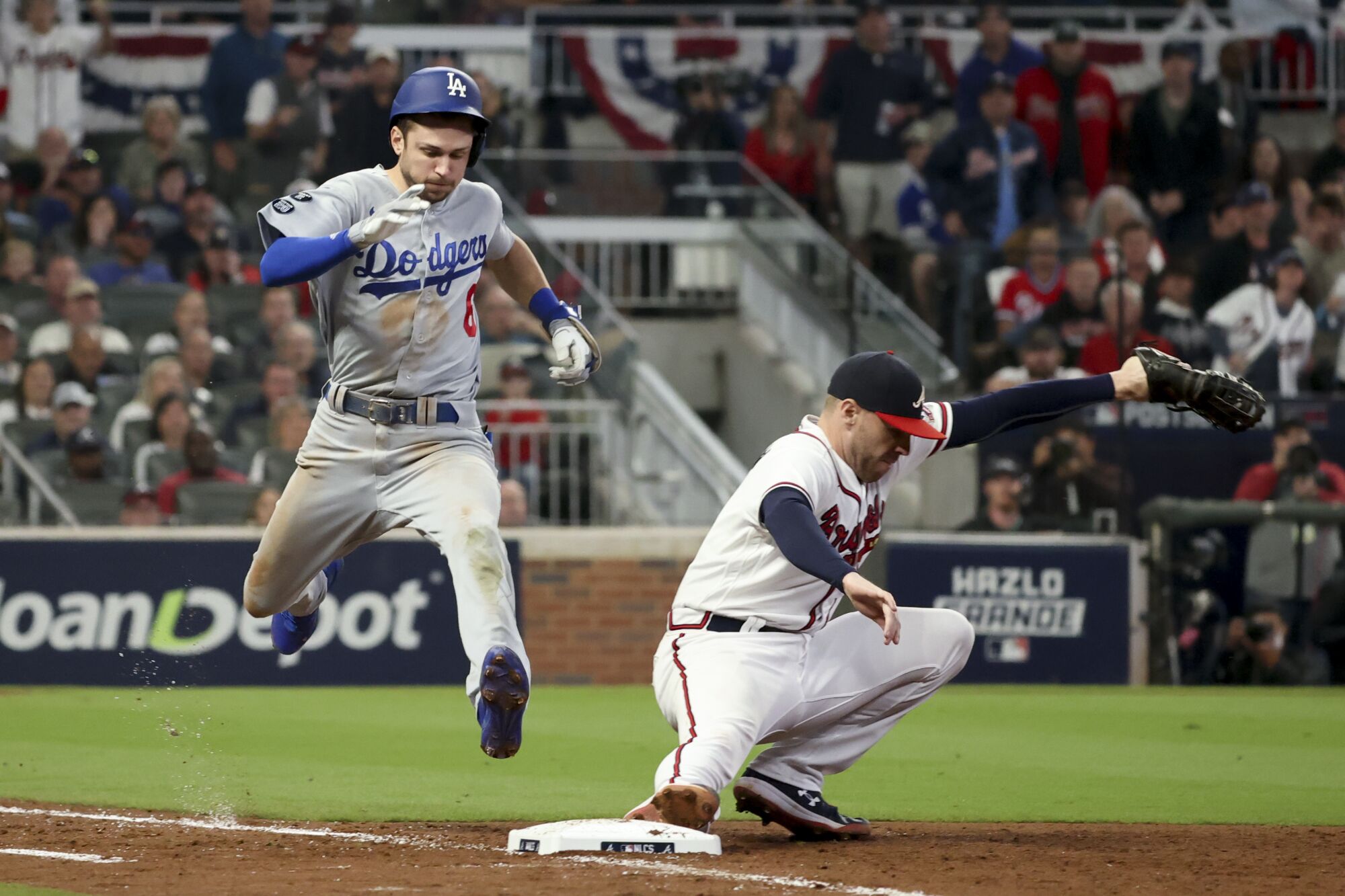 Braves first baseman Freddie Freeman, right, forces out Dodgers' Trea Turner at first on an infield ground ball