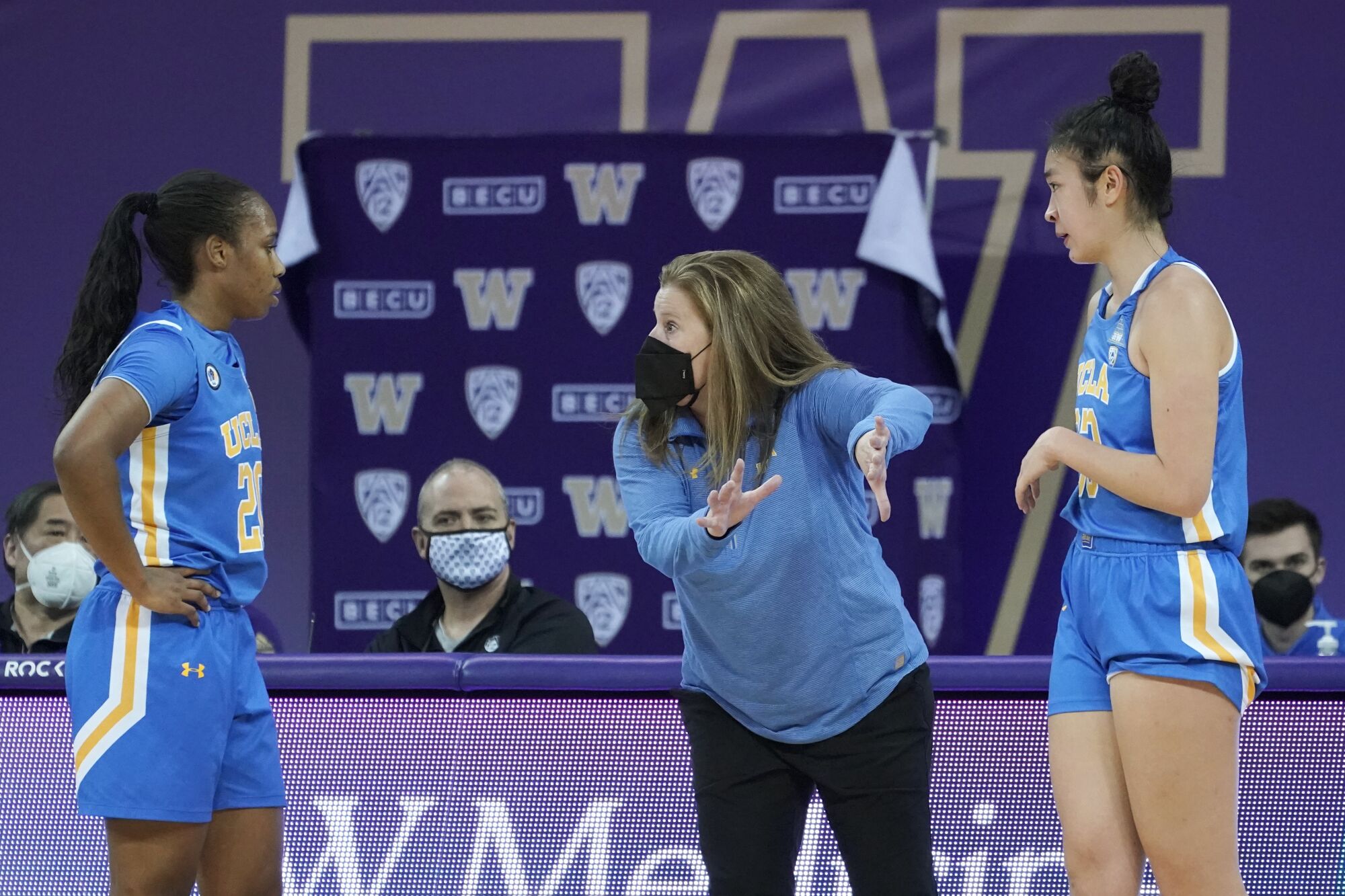 Coach Cori Close talks with Charisma Osborne and Natalie Chou.