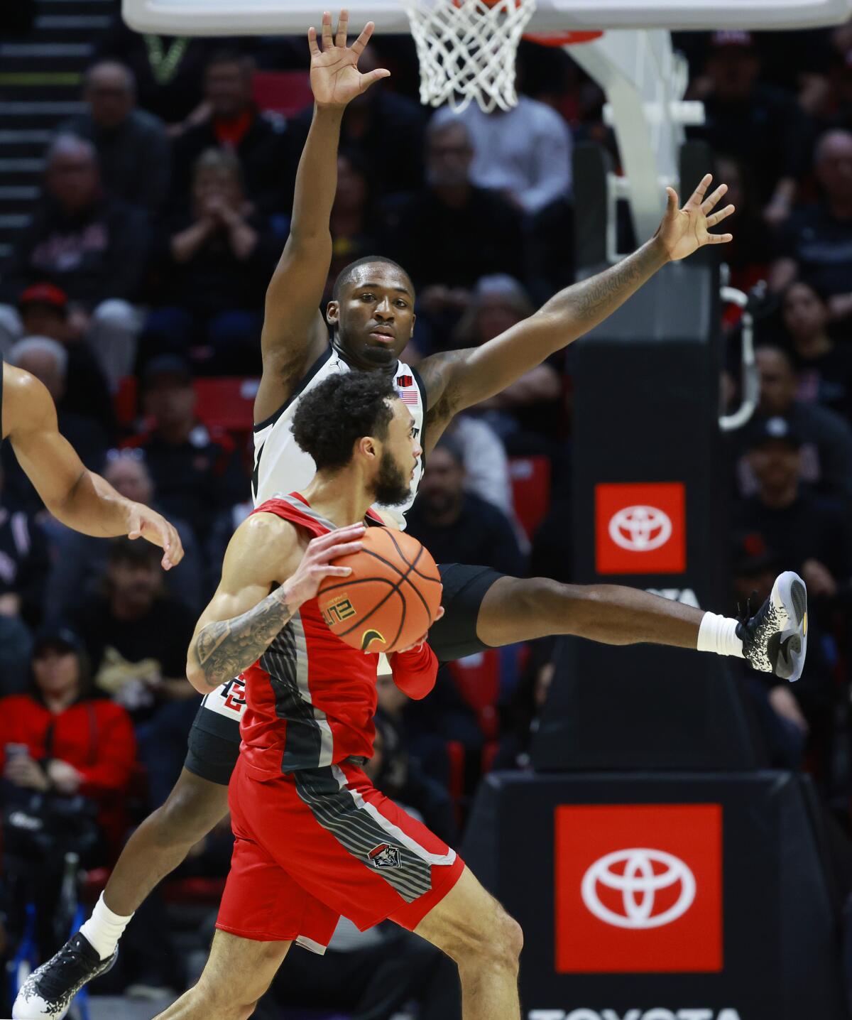 San Diego State's Darrion Trammell protects New Mexico's Jaelen House.