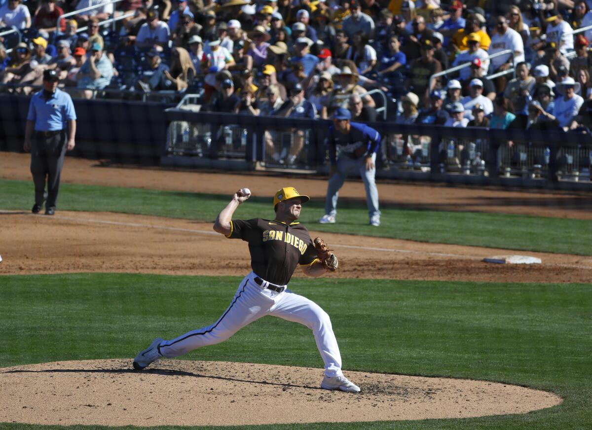 Kevin Kopps throws against the Dodgers.