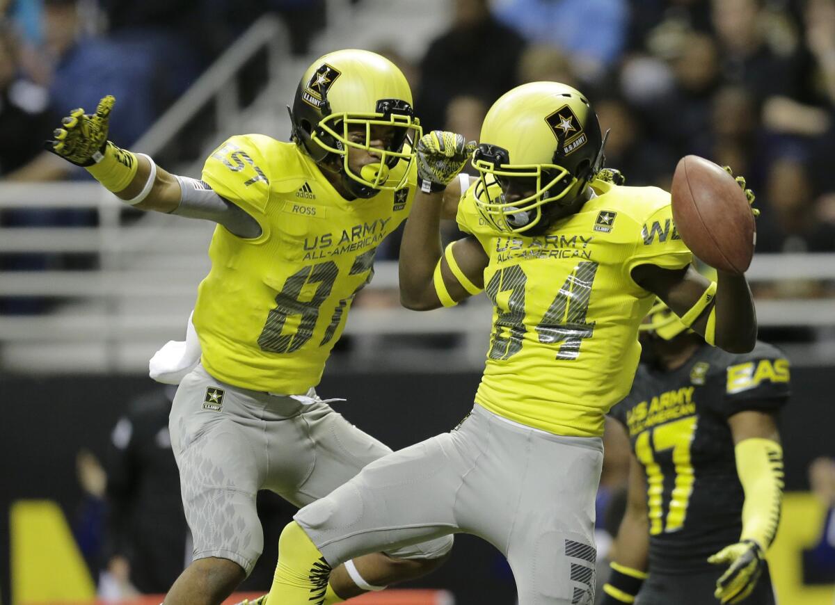 Derrick Dillon (84) and Ykili Ross (87) celebrate after Dillon's 30 yard touchdown during the first half for the West team in the Army All-American Bowl game.