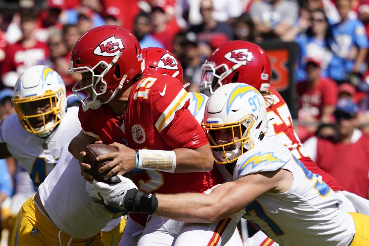 The Chiefs' Patrick Mahomes (15) is sacked by the Chargers' Joey Bosa (97) in the first half.
