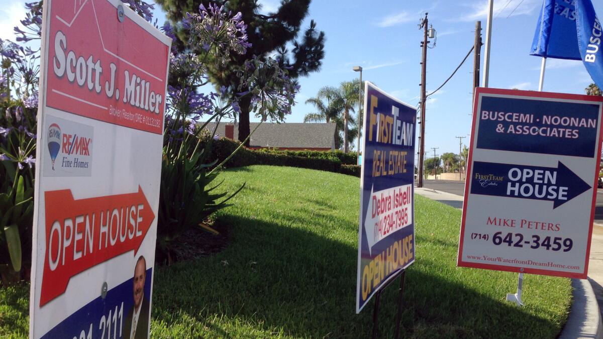 Home prices in Southern California held steady in September compared with August's levels. Above, a file photo of open-house signs in Huntington Beach.
