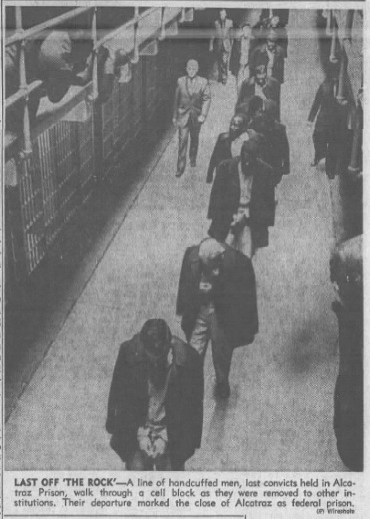 Men walk with their heads down.