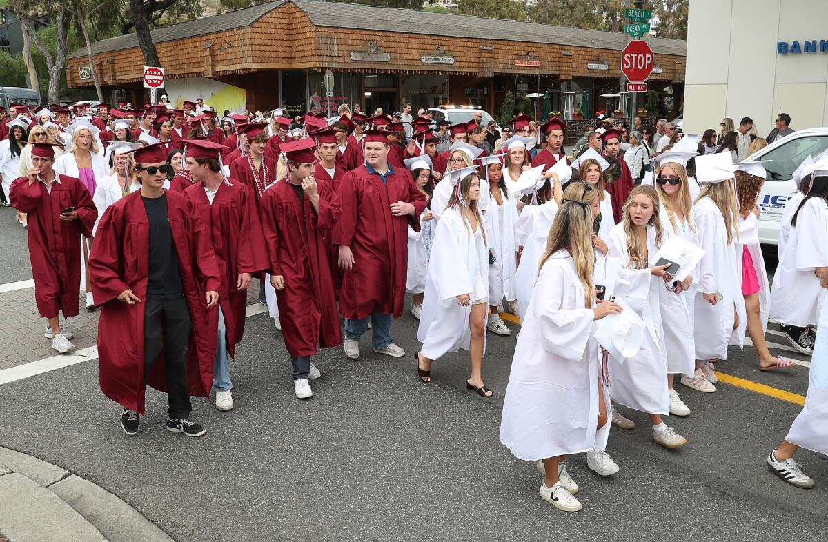 The Laguna Beach High class of 2025 parades down Ocean Avenue on Tuesday in downtown Laguna Beach.