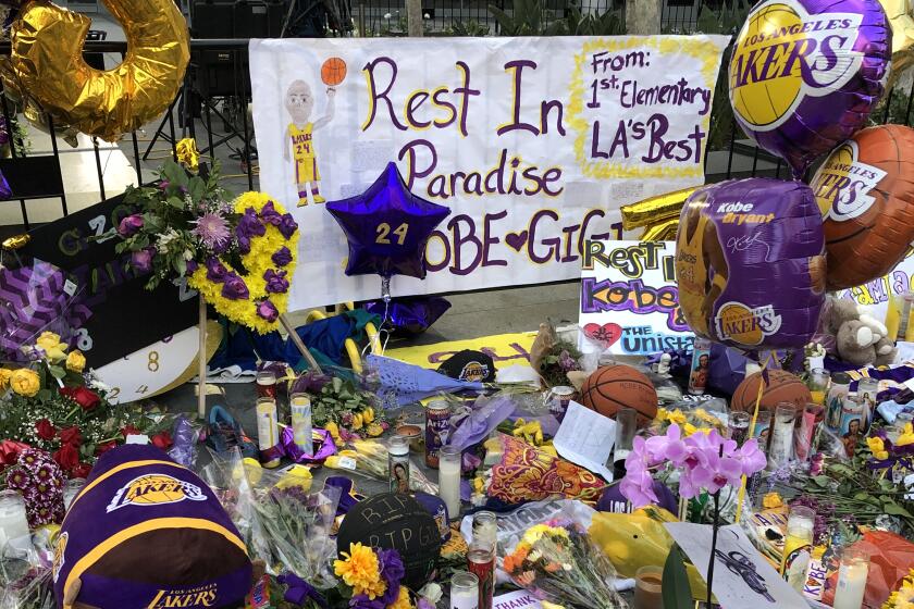 Flowers and tributes to former Lakers star Kobe Bryant, his daughter Gianna and the seven other victims of a helicopter crash are seen outside Staples Center and L.A. Live on Jan. 30.