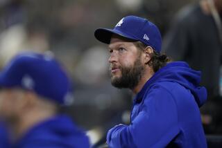 Los Angeles Dodgers starting pitcher Clayton Kershaw looks on from the dugout during the fourth inning.