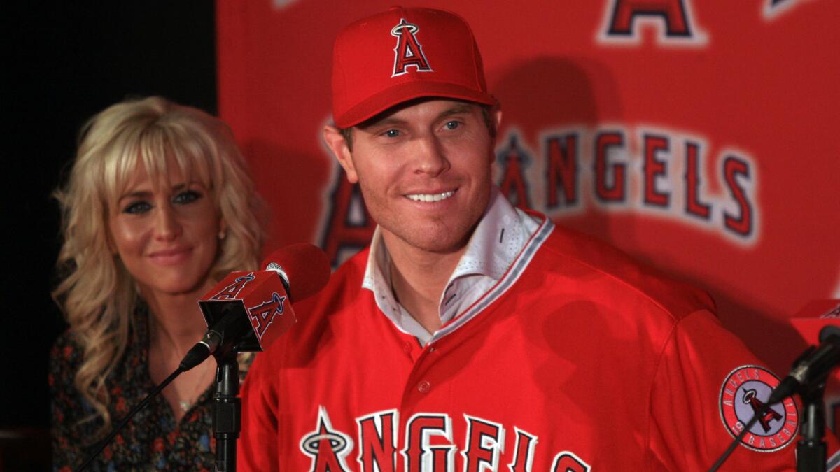 Angels outfielder Josh Hamilton smiles while sitting next to his wife, Katie, during his introductory Angels news conference on Dec. 15, 2012.