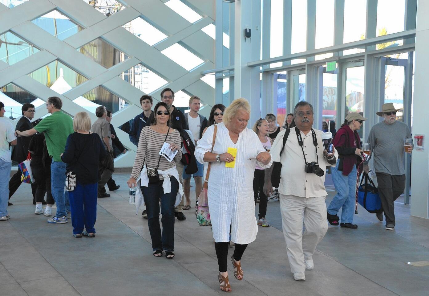 Concert attendees make their way into the newly constructed Plaza Pacifica on Thursday. The plaza is a new entrance area and lobby for the Pacific Amphitheatre.