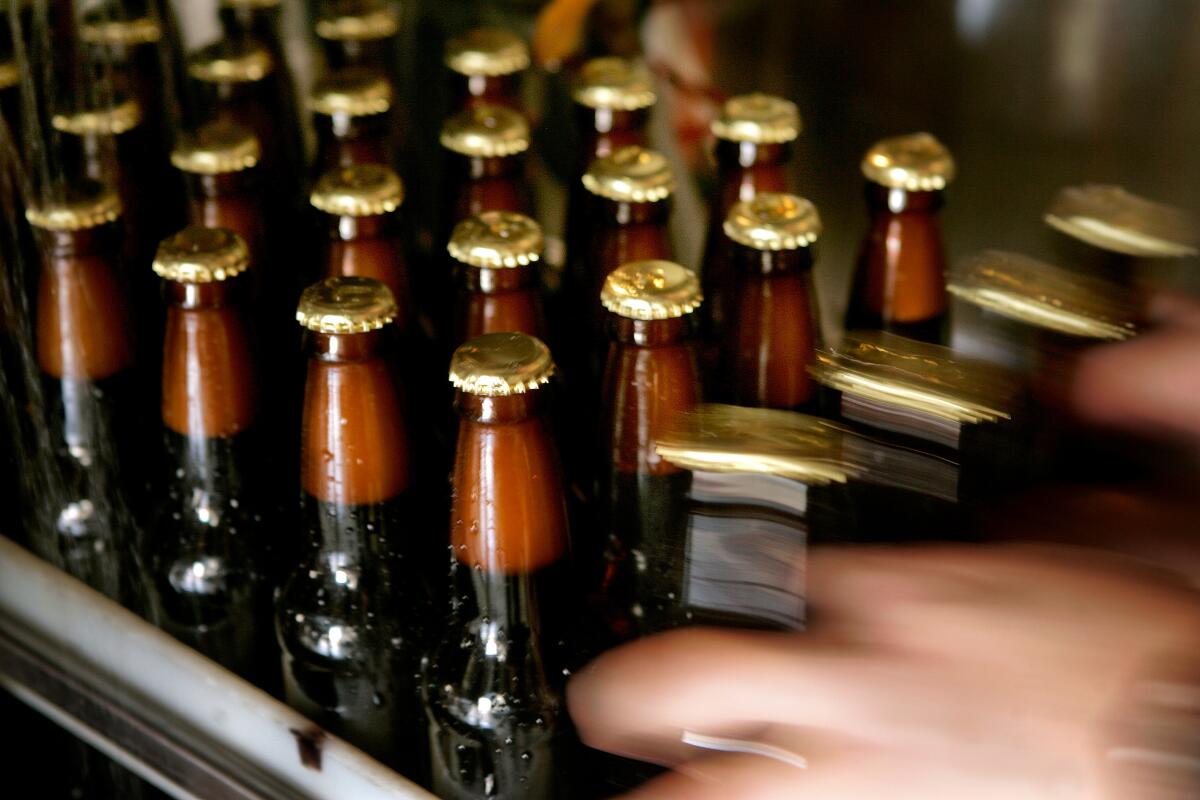 Bottles of Fireman's Brew beer make their way down the production line at Skyscraper Brewing in El Monte