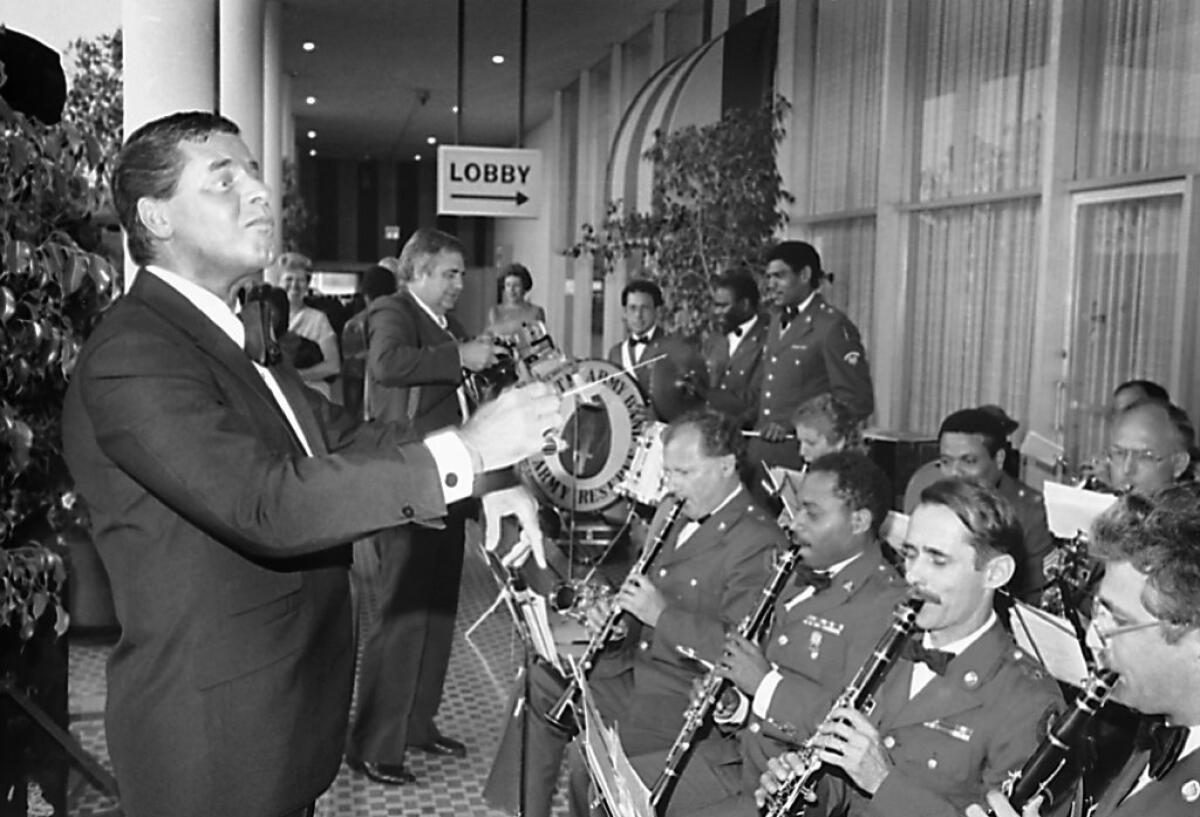 Jerry Lewis, left, performs with the U.S. Army Reserve Band at the Beverly Hilton prior to his receipt of the Defense Distinguished Service Medal in 1985.