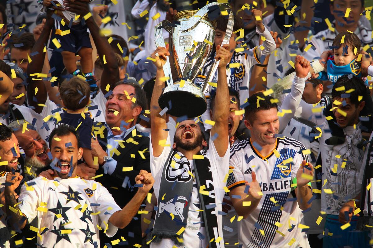 Landon Donovan hoists the MLS Cup trophy during the Galaxy's celebration at StubHub Center.