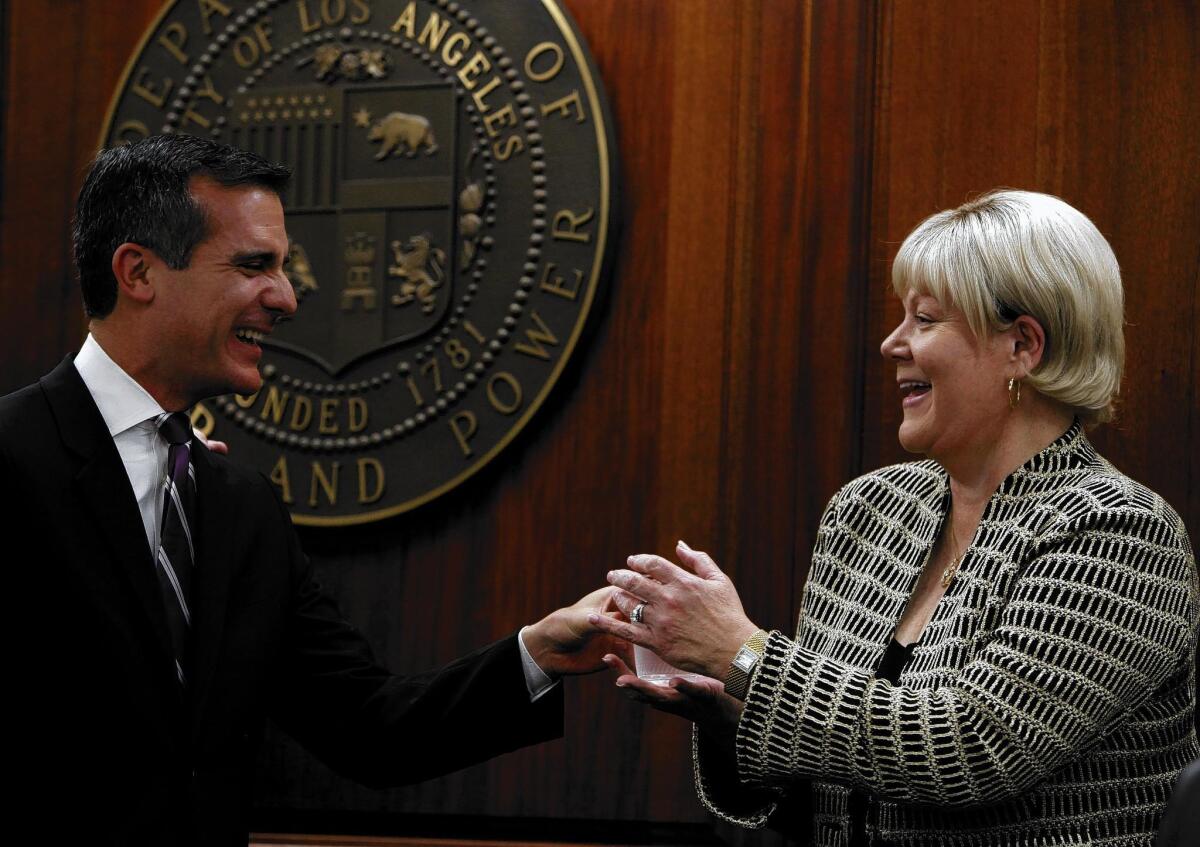 L.A. Mayor Eric Garcetti is shown with Los Angeles Department of Water and Power General Manager Marcie Edwards in January 2014. Edwards apologized Tuesday for criticizing a city audit of two controversial DWP nonprofits.
