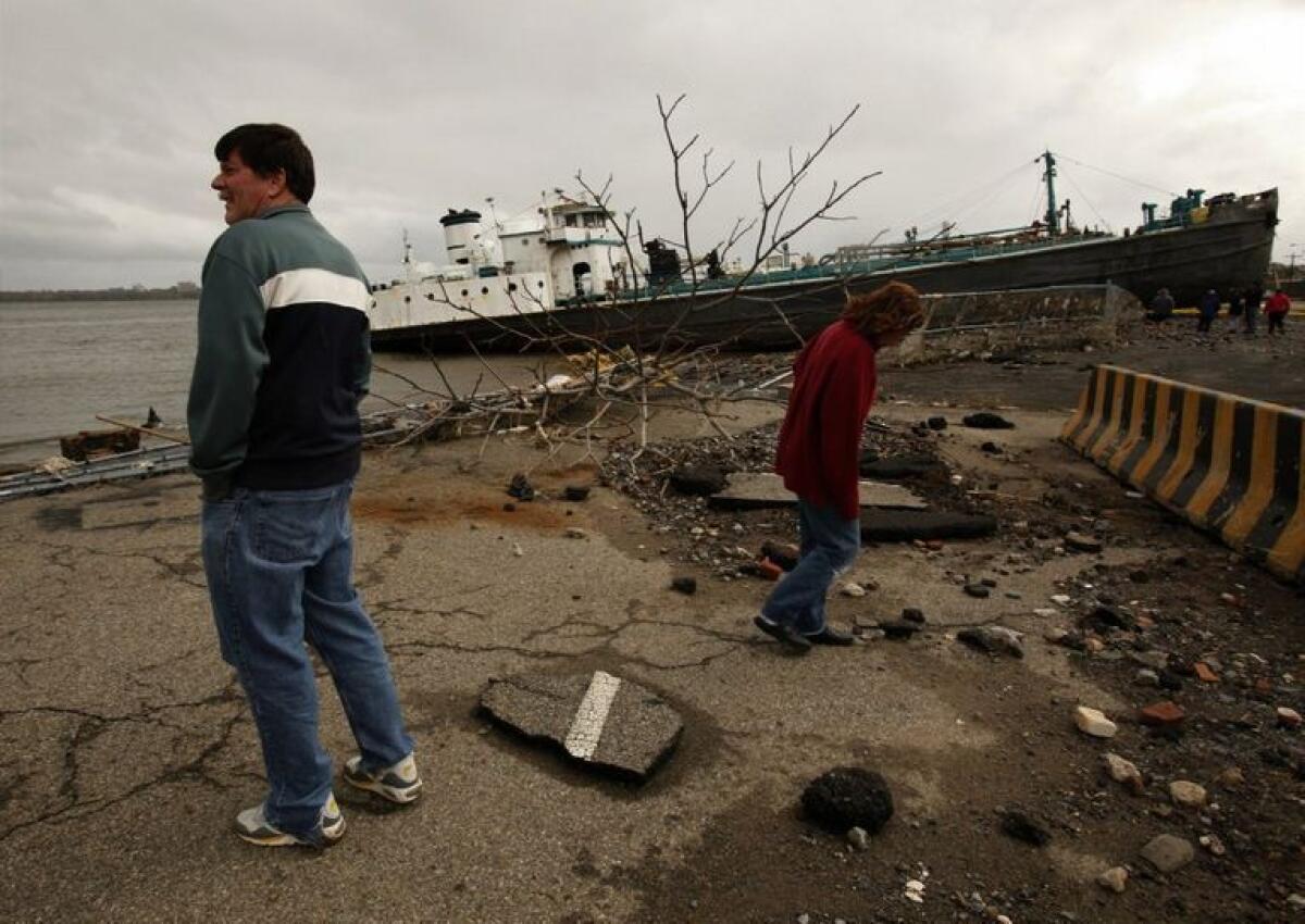 On Staten Island, New York, a large ship is grounded on Front Street, Tuesday, October 30, 2012, as residents assess damage after Hurricane Sandy.