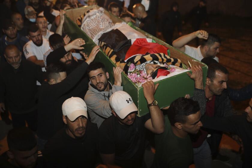 Muslim men carry the body of Iyad Halak to burial after Israeli police shot him dead in Jerusalem's old city, Sunday, May 31, 2020. Israel's defense minister has apologized for the Israeli police's deadly shooting of an unarmed Palestinian man who was autistic. (AP Photo/Mahmoud Illean)