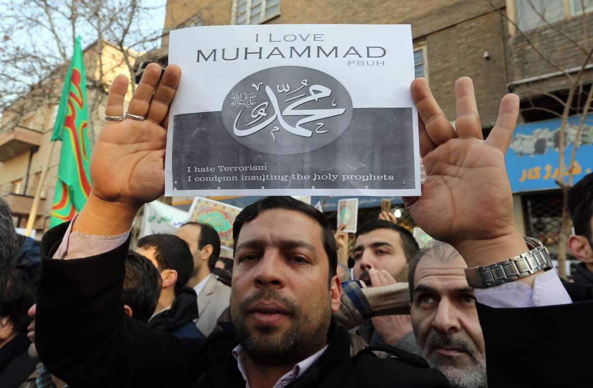 A man shows a placard during a protest at the French Embassy in Tehran on Jan. 19 denouncing the printing of satirical sketches of the prophet Muhammad by the French satirical weekly Charlie Hebdo.