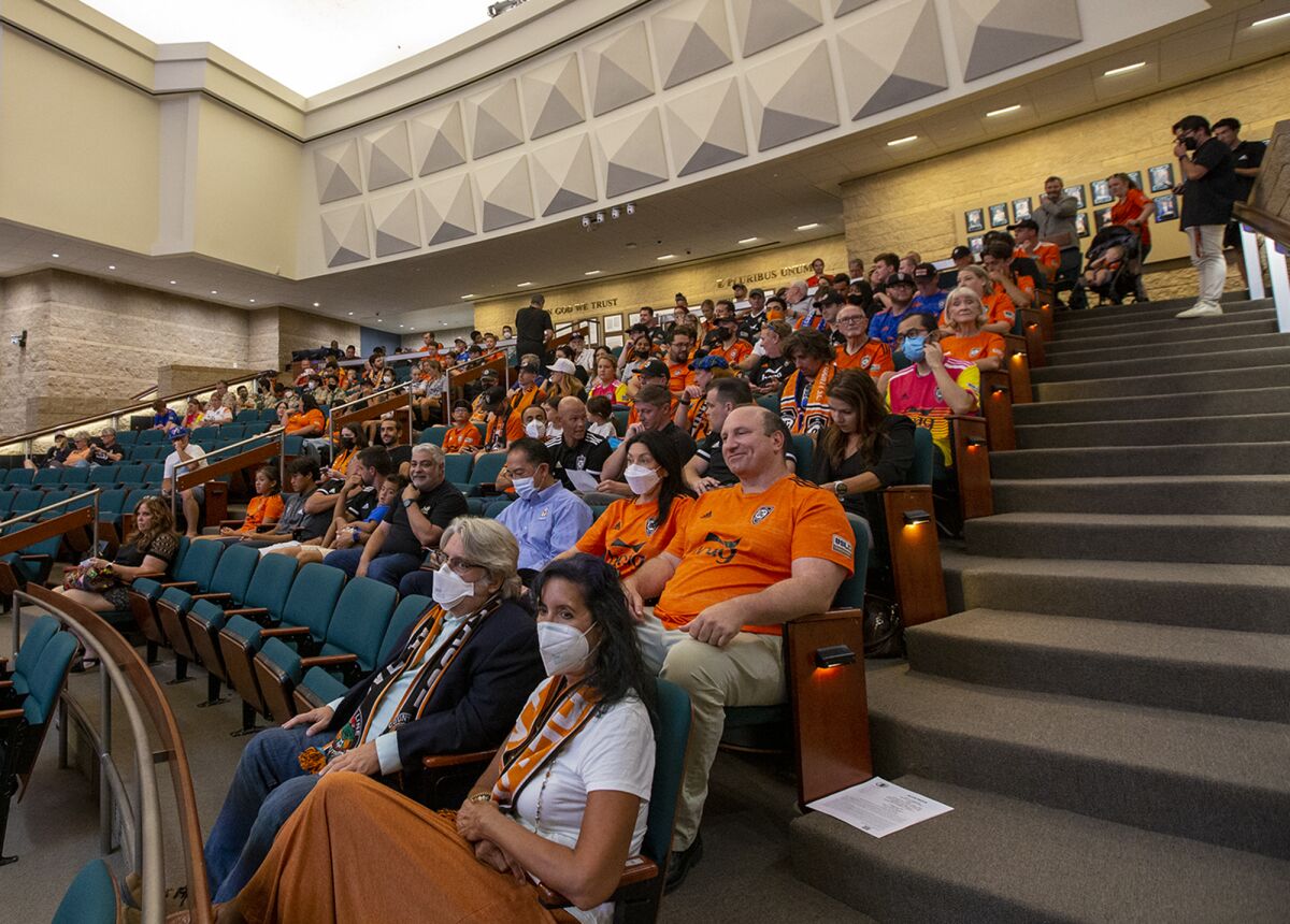 James Keston, the owner of Orange County Soccer Club, and supporters of the team sit inside Irvine City Council Chambers.