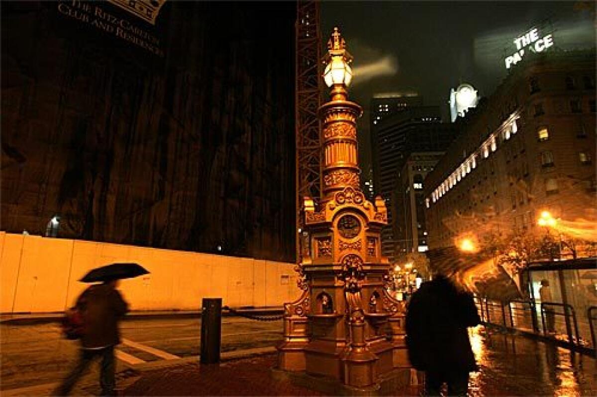 Lotta's Fountain in downtown San Francisco glows on a rainy, chilly evening. 