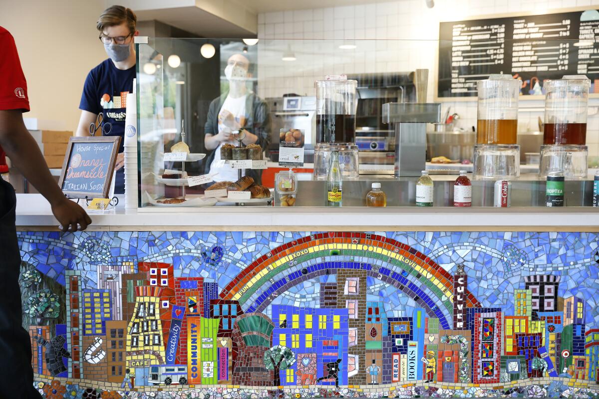 A mosaic depicting the Culver City community lines the cafe counter at Village Well Books & Coffee in Culver City.