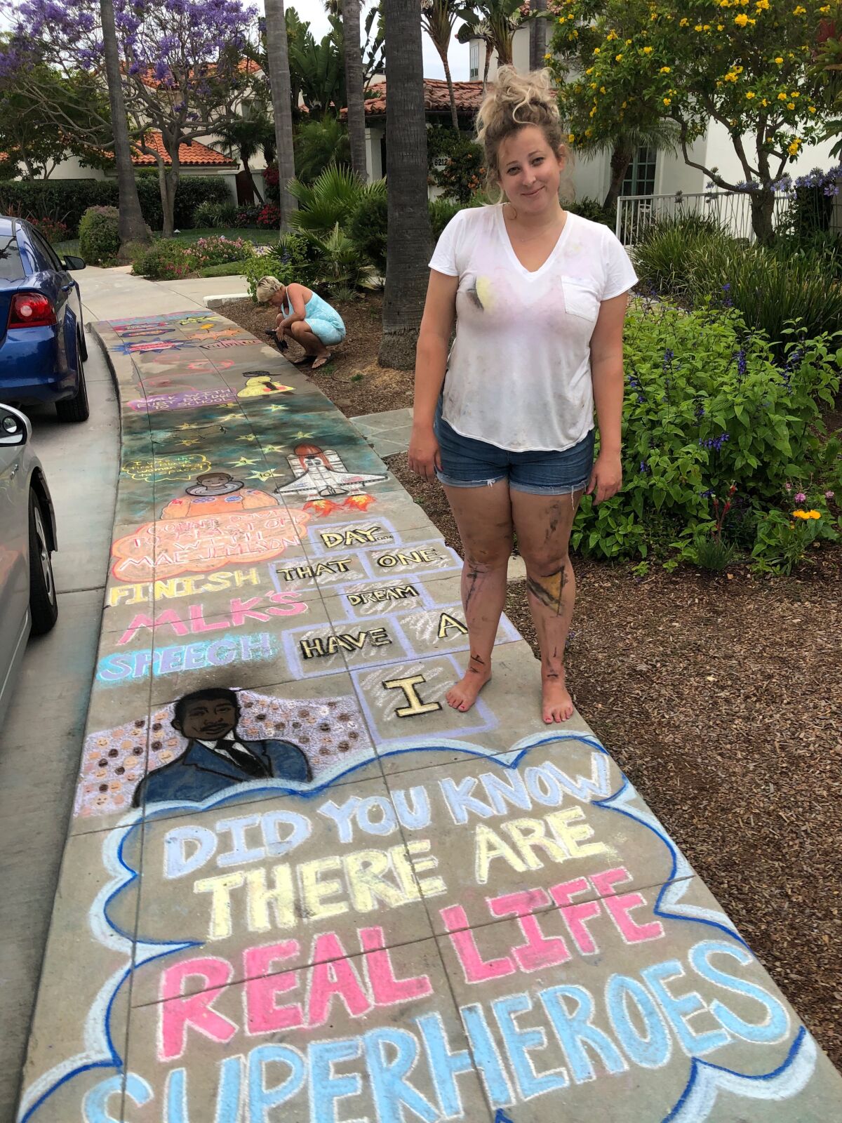 Amelia Leidy shows a recent sidewalk chalk "sensory path" she drew in the Upper Hermosa area of La Jolla.
