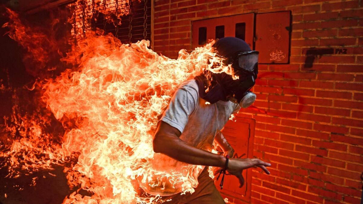 Ronaldo Schemidt's searing photo shows a protester in Caracas, Venezuela, in 2017.