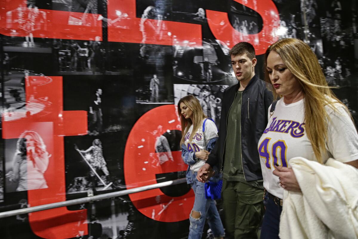 Lakers reserve center Ivaca Zubac walks with his mother, Diana, right, and his girlfriend Kristina Prisc, after a game at Staples Center.