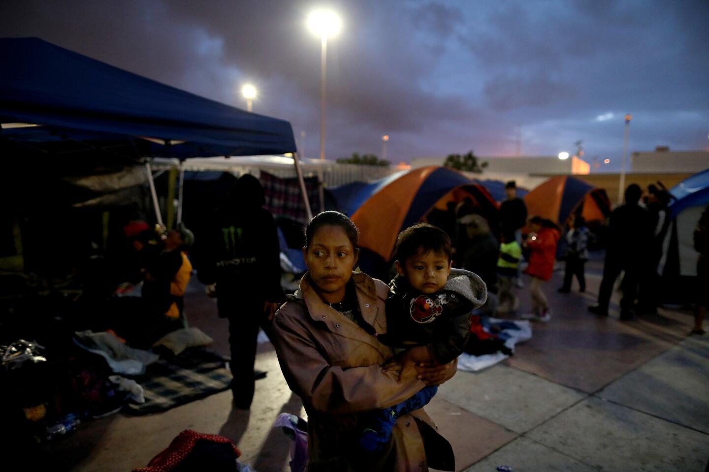Night falls on a camp where nearly 200 Central American migrants seeking asylum in the U.S. gather on their third day near the El Chaparral port of entry in Tijuana.