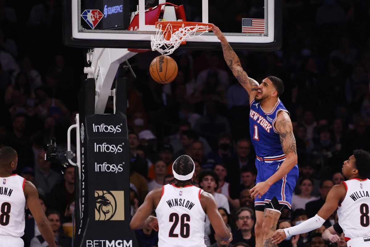 New York Knicks' Obi Toppin (1) dunks against the Portland Trail Blazers during the second quarter of an NBA basketball game Wednesday, March 16, 2022, in New York. (AP Photo/Jason DeCrow)