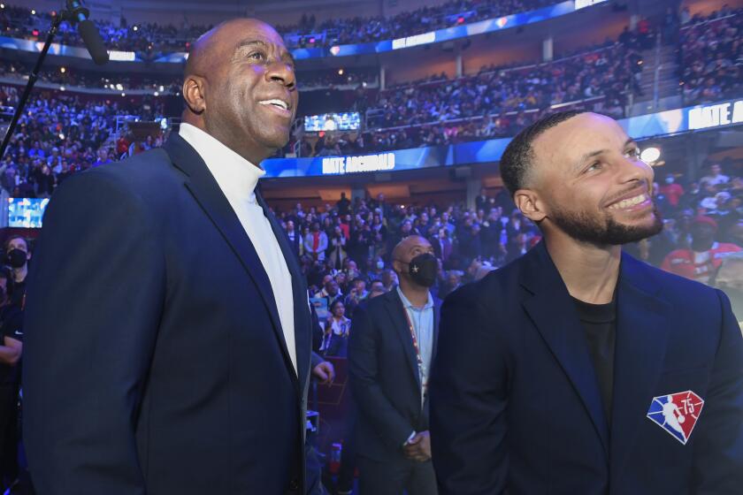 NBA Legends, Magic Johnson and Stephen Curry smile during 71st NBA All-Star Game as part of 2022 NBA All Star Weekend