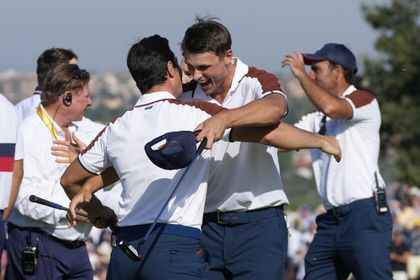 Europe's Viktor Hovland, left and Europe's Ludvig Aberg hug on the 11th green after defeating the United States pair of Scottie Scheffler and Brooks Koepka 9&7, during their morning Foursomes match at the Ryder Cup golf tournament at the Marco Simone Golf Club in Guidonia Montecelio, Italy, Saturday, Sept. 30, 2023. (AP Photo/Gregorio Borgia )