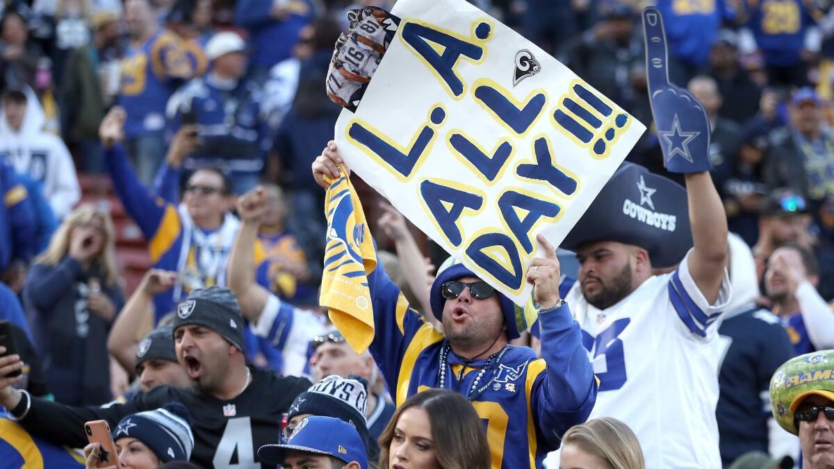 Rams fans cheer among Cowboys fans during the Rams' Divisional Round victory over Dallas at the Coliseum on Jan. 12.