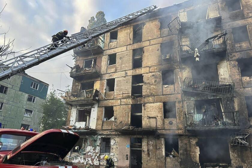 In this photo released by Dnipro Regional Administration, emergency workers extinguish a fire after missiles hit a multi-story apartment building in Kryvyi Rih, Ukraine, Tuesday, June 13, 2023. (Dnipro Regional Administration via AP)