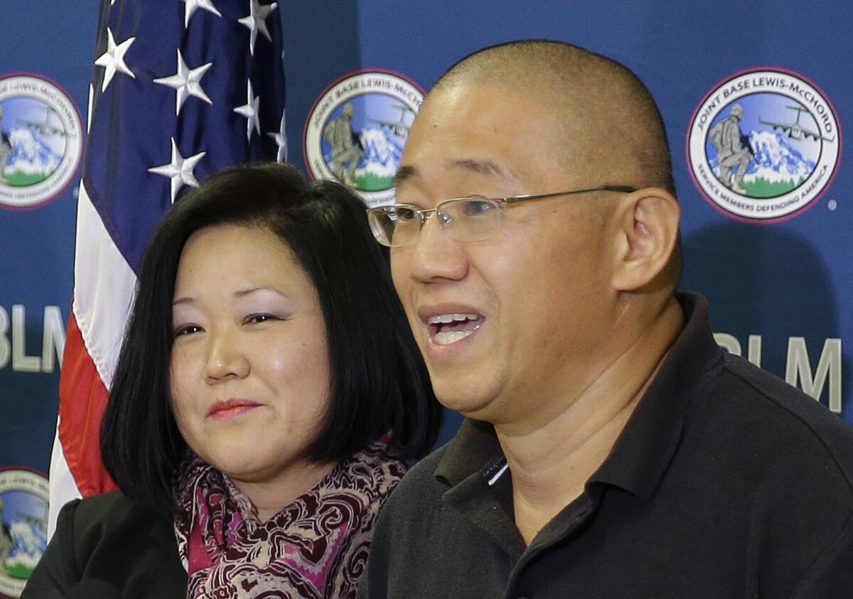 Kenneth Bae, right, who had been held in North Korea since 2012, talks to reporters after he arrived Saturday at Joint Base Lewis-McChord in Washington. At left is his sister Terri Chung.