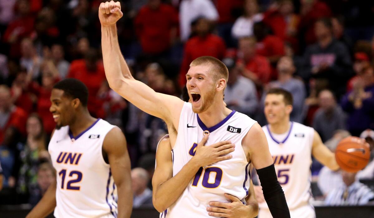 Northern Iowa forward Seth Tuttle (10) is embraced by teammate Jeremy Morgan after beating Illinois State in the Missouri Valley Conference championship game on Sunday.